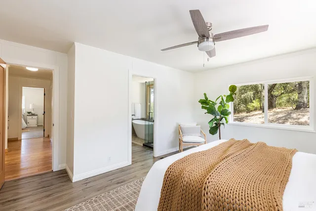 a bathroom with a granite countertop sink and a bathtub