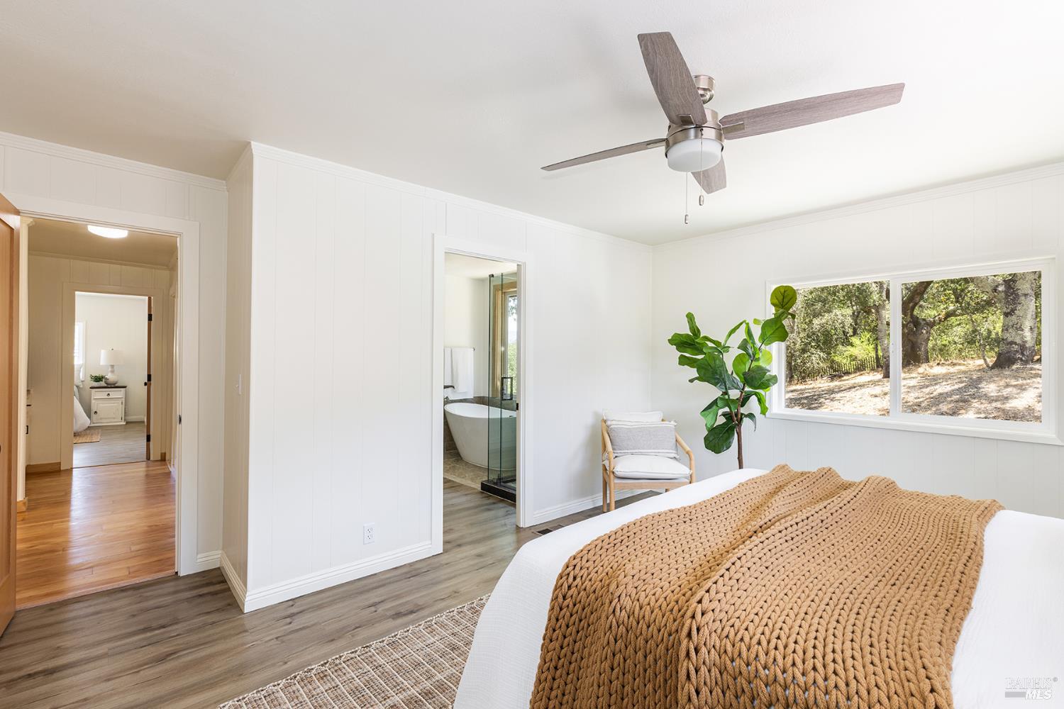 1676 Chiquita Road Healdsburg, CA 95448 - Photo 22 of 45 a spacious bedroom with a bed and a chandelier