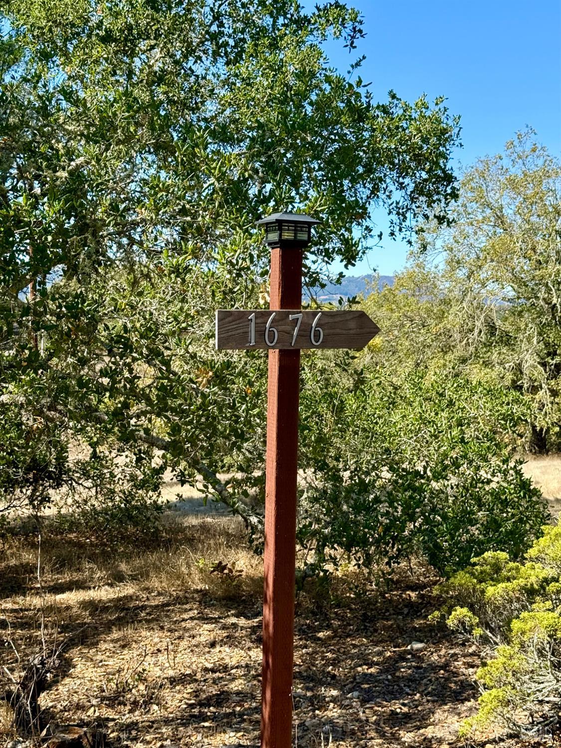 1676 Chiquita Road Healdsburg, CA 95448 - Photo 36 of 45 a sign board with a tree in the background