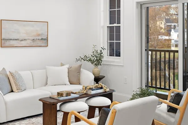 a living room with fireplace furniture and a rug