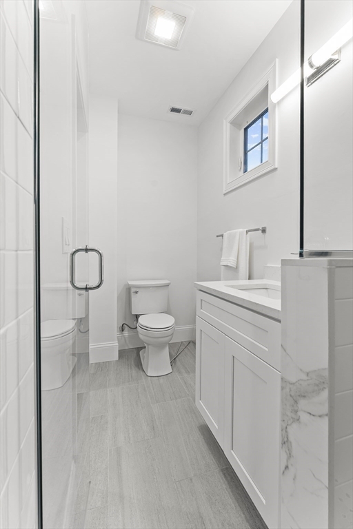 272 Lincoln Street, Unit 302 Marlborough, MA 01752 - Photo 14 of 27 a bathroom with a toilet a sink and mirror