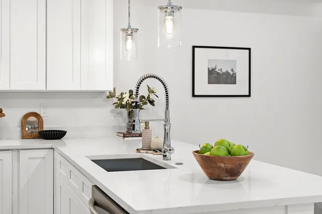 a kitchen with a sink cabinets and stainless steel appliances