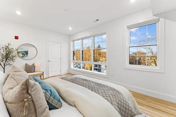 a bedroom with a bed and chair