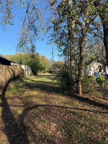 a view of a yard with large trees