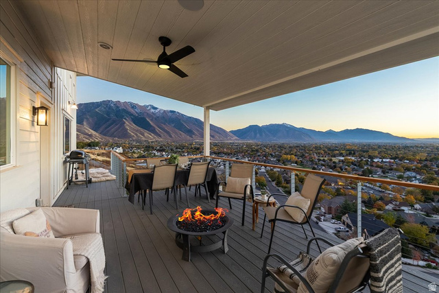1800 Spring Oaks Drive Springville, UT 84663 - Photo 30 of 68 Wooden terrace with a mountain view, a ceiling fan, a grill, an outdoor fire pit, and outdoor dining area