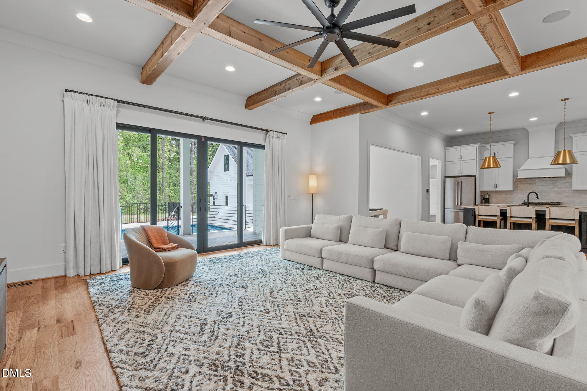 Views to dining room, kitchen, and mud room. Detached garage visible through patio doors.