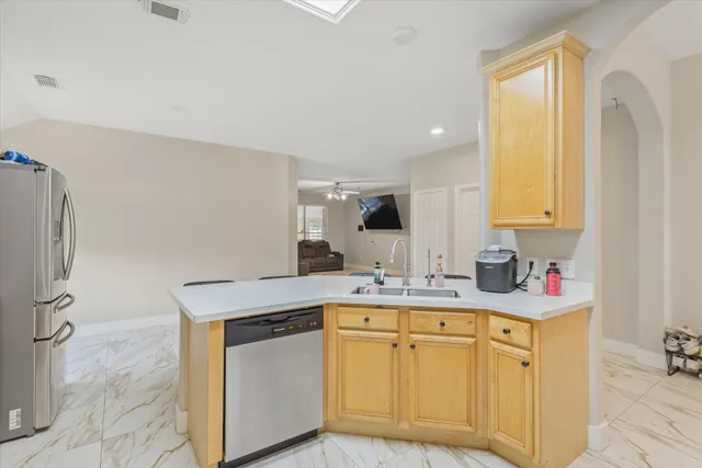 a kitchen with stainless steel appliances a sink stove and cabinets