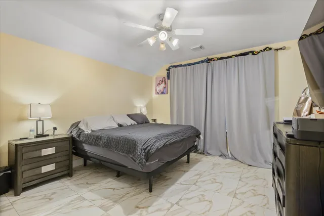 a bedroom with a bed and a tv