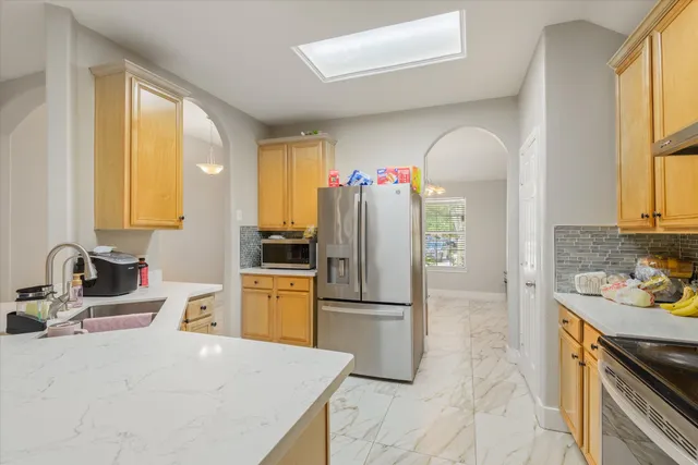 a kitchen with a refrigerator and a sink