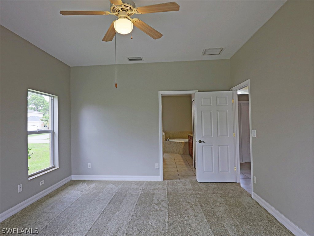 18242 Hemlock Road Fort Myers, FL 33967 - Photo 14 of 29 an empty room with fan and windows