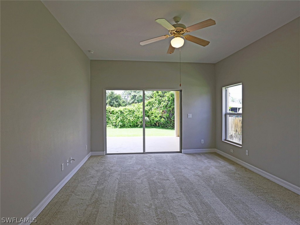 18242 Hemlock Road Fort Myers, FL 33967 - Photo 15 of 29 an empty room with windows and ceiling fan