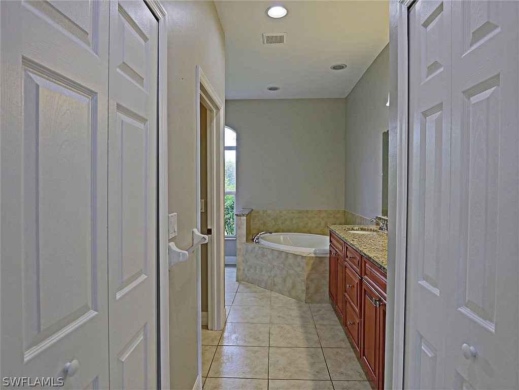 18242 Hemlock Road Fort Myers, FL 33967 - Photo 16 of 29 a bathroom with a bathtub and shower