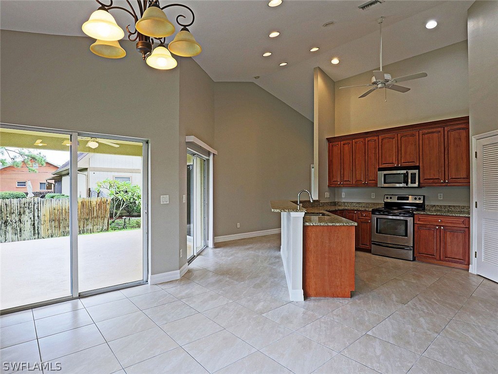 18242 Hemlock Road Fort Myers, FL 33967 - Photo 25 of 29 a kitchen with stainless steel appliances granite countertop a refrigerator a sink a stove top oven and a dishwasher next to a window