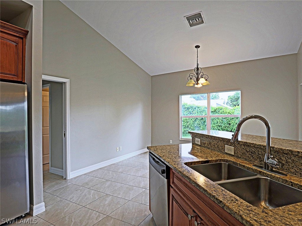 18242 Hemlock Road Fort Myers, FL 33967 - Photo 28 of 29 a kitchen with a sink and a refrigerator