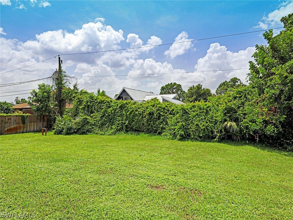 18242 Hemlock Road Fort Myers, FL 33967 - Photo 7 of 29 a view of a garden with a building in the background