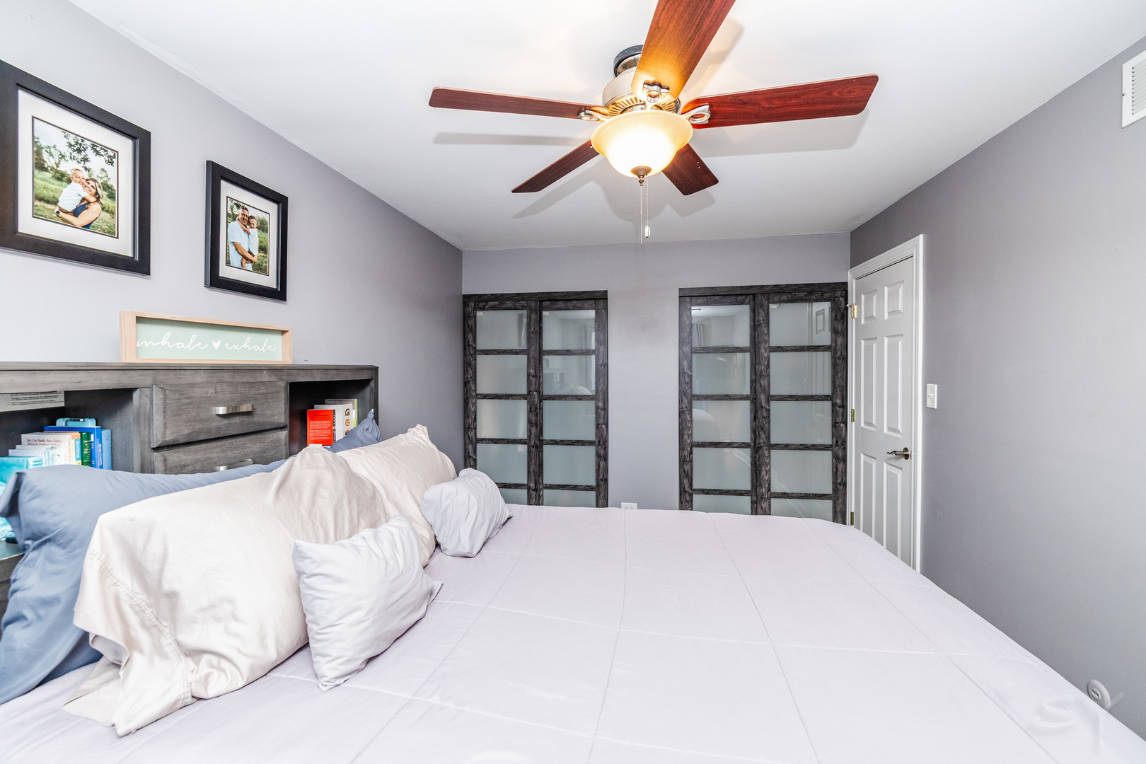 449 Geneva Road Glen Ellyn, IL 60137 - Photo 17 of 21 a bedroom with a large bed and a chandelier