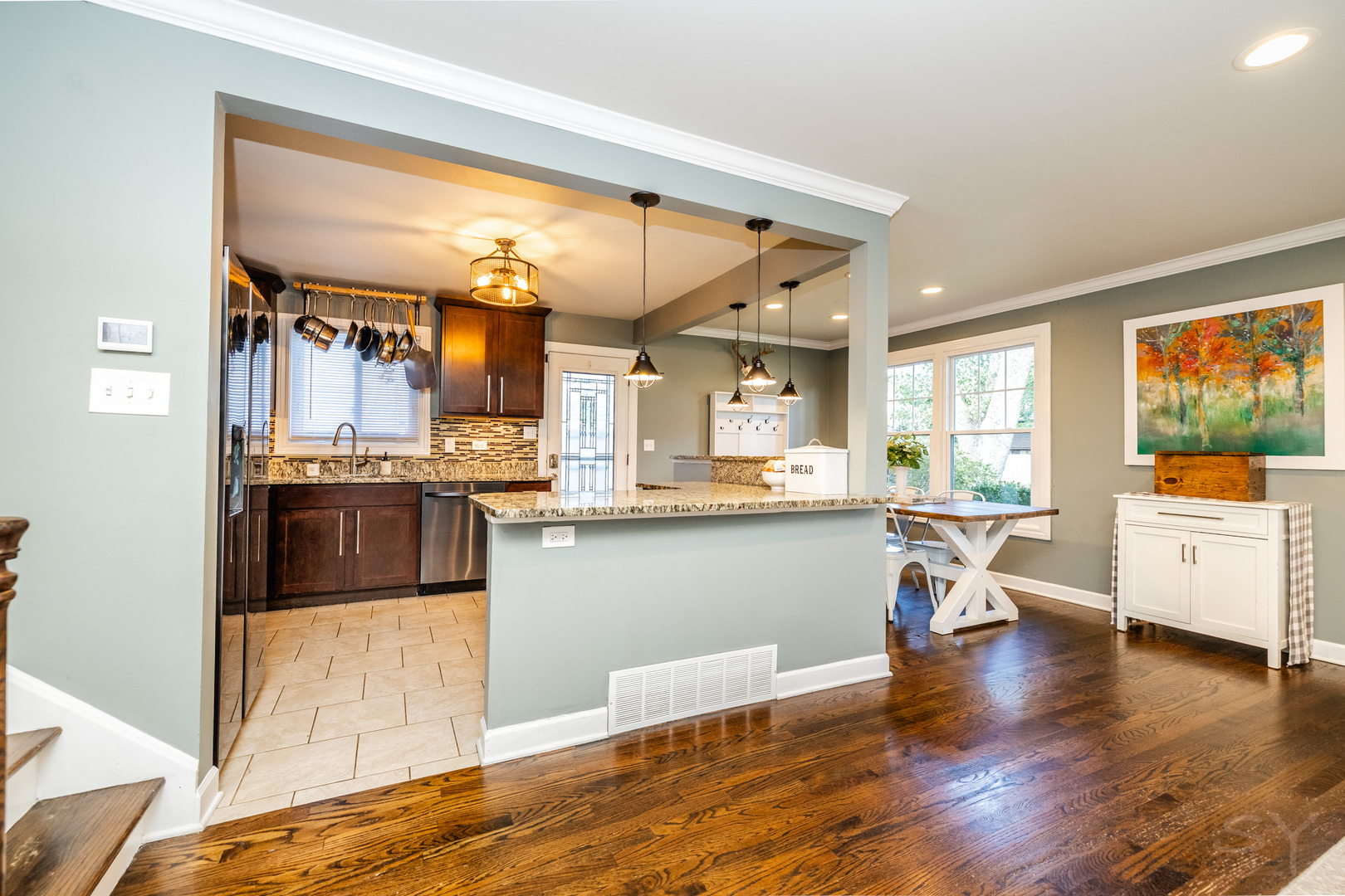 449 Geneva Road Glen Ellyn, IL 60137 - Photo 9 of 21 a kitchen with stainless steel appliances wooden floor and dining table