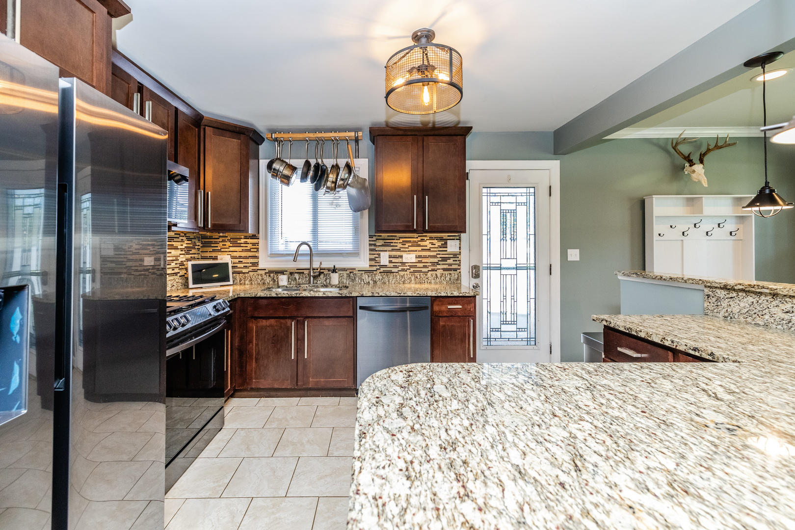 449 Geneva Road Glen Ellyn, IL 60137 - Photo 10 of 21 a kitchen with stainless steel appliances granite countertop a sink stove and refrigerator