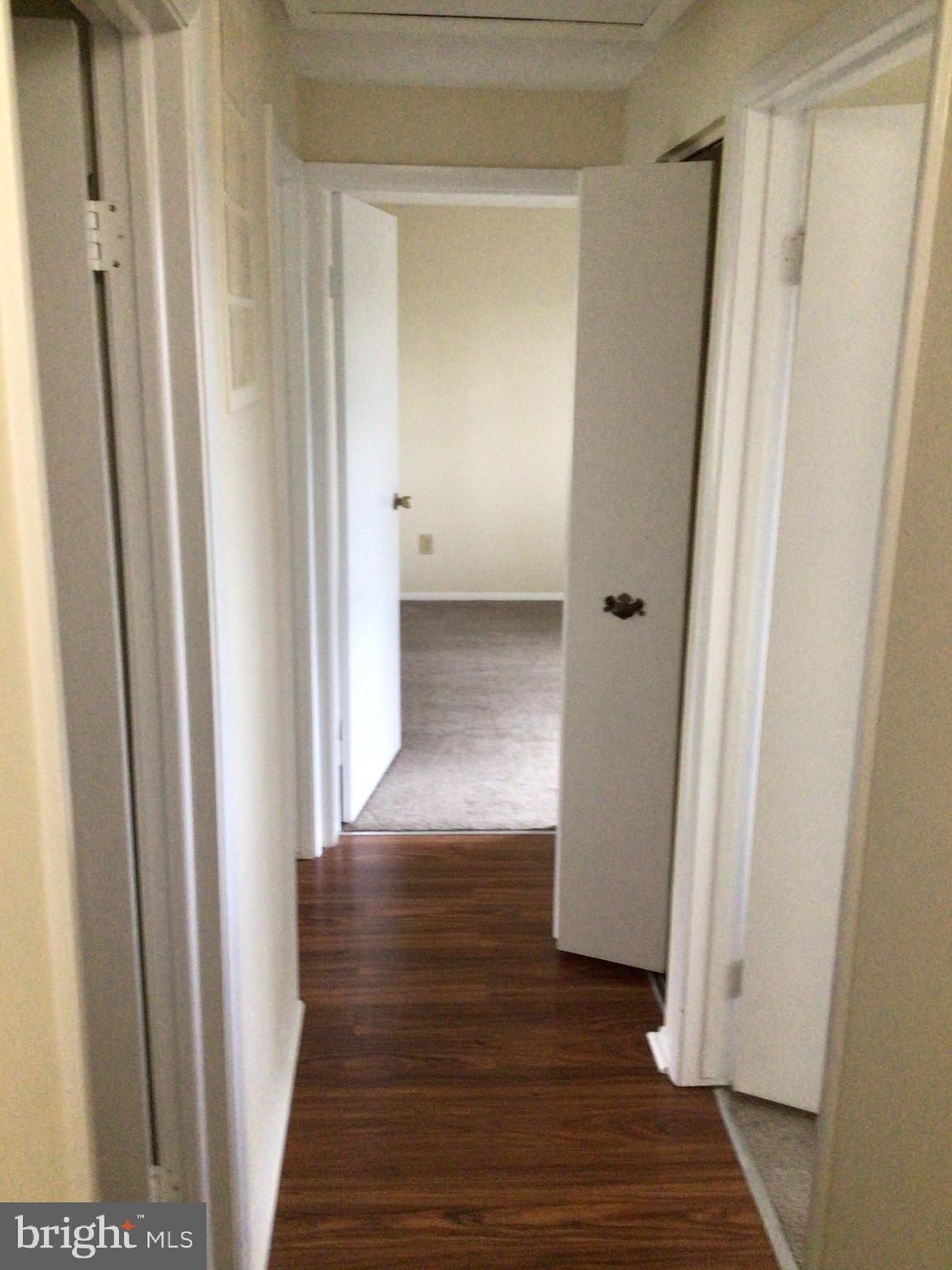 7679 Tuckerman Drive Hanover, MD 21076 - Photo 14 of 30 a view of a hallway with wooden floor