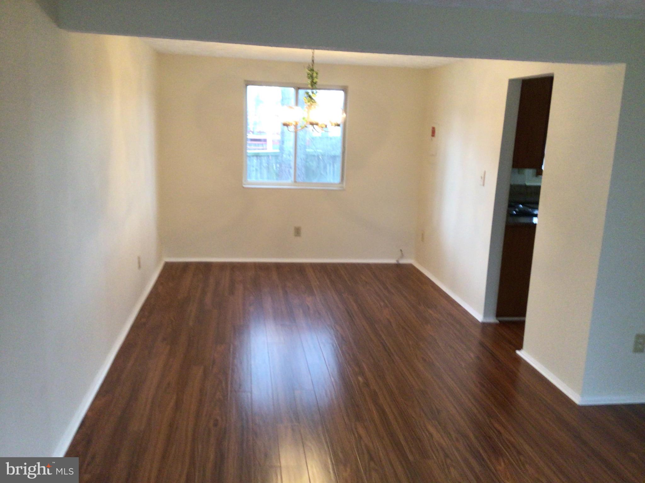 7679 Tuckerman Drive Hanover, MD 21076 - Photo 4 of 30 an empty room with wooden floor and windows