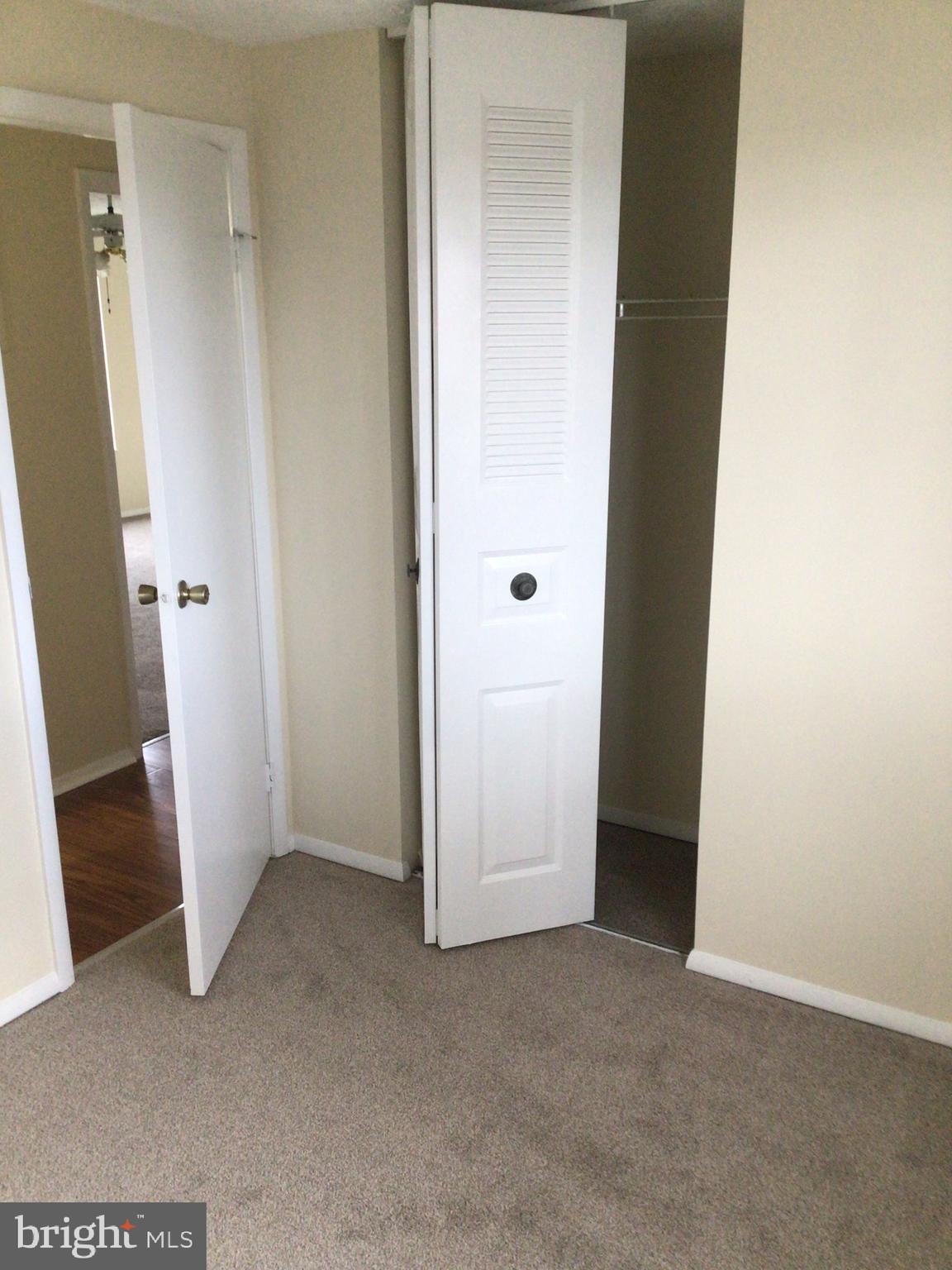 7679 Tuckerman Drive Hanover, MD 21076 - Photo 10 of 30 an empty room with wooden door