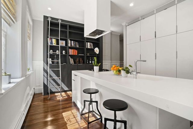 a dining room with furniture and wooden floor