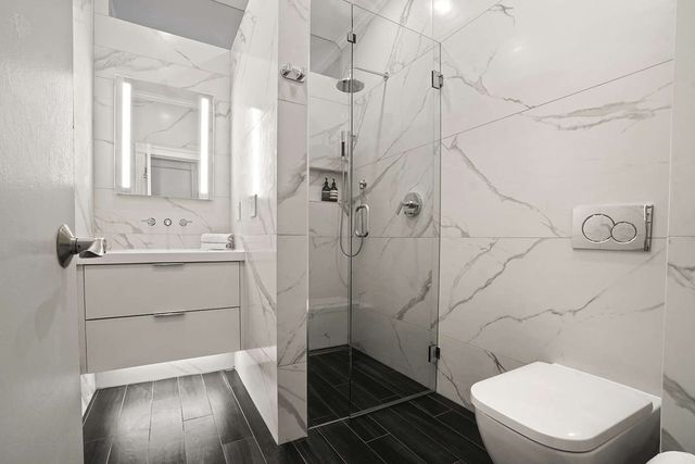 a bathroom with a sink toilet and shower