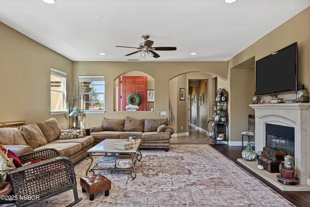 a living room with kitchen island furniture and a chandelier