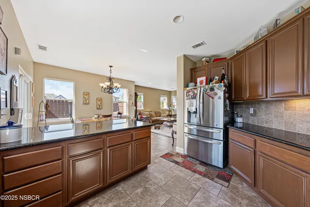 a bathroom with a granite countertop tub a double vanity sink a mirror and a bathtub
