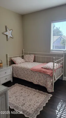 a bedroom with two beds and a window