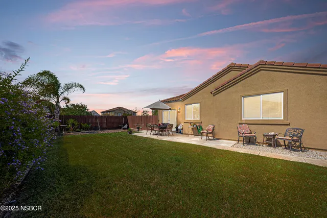 a view of a backyard with sitting area