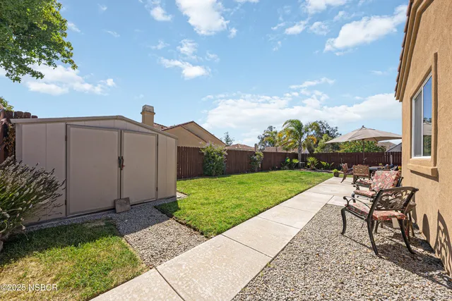 a view of a house with backyard porch and sitting area