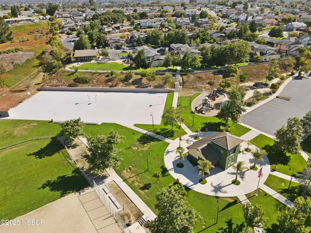 an aerial view of a house with a big yard