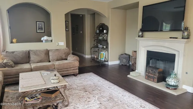 a living room with furniture and a fireplace