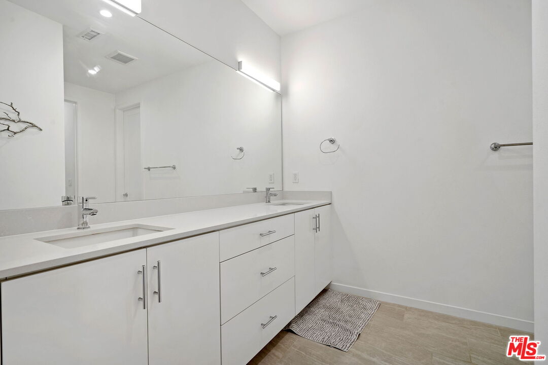 305 Placemark Costa Mesa, CA 92626 - Photo 9 of 20 a bathroom with a sink and a mirror