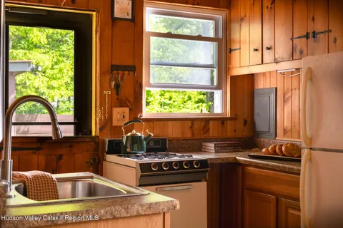 a kitchen with a sink a stove and a window