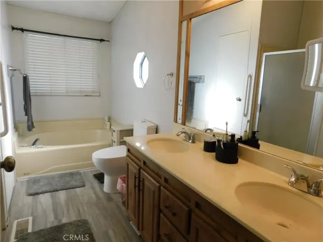 a bathroom with a tub sink and mirror