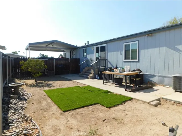 a view of a backyard with sitting area