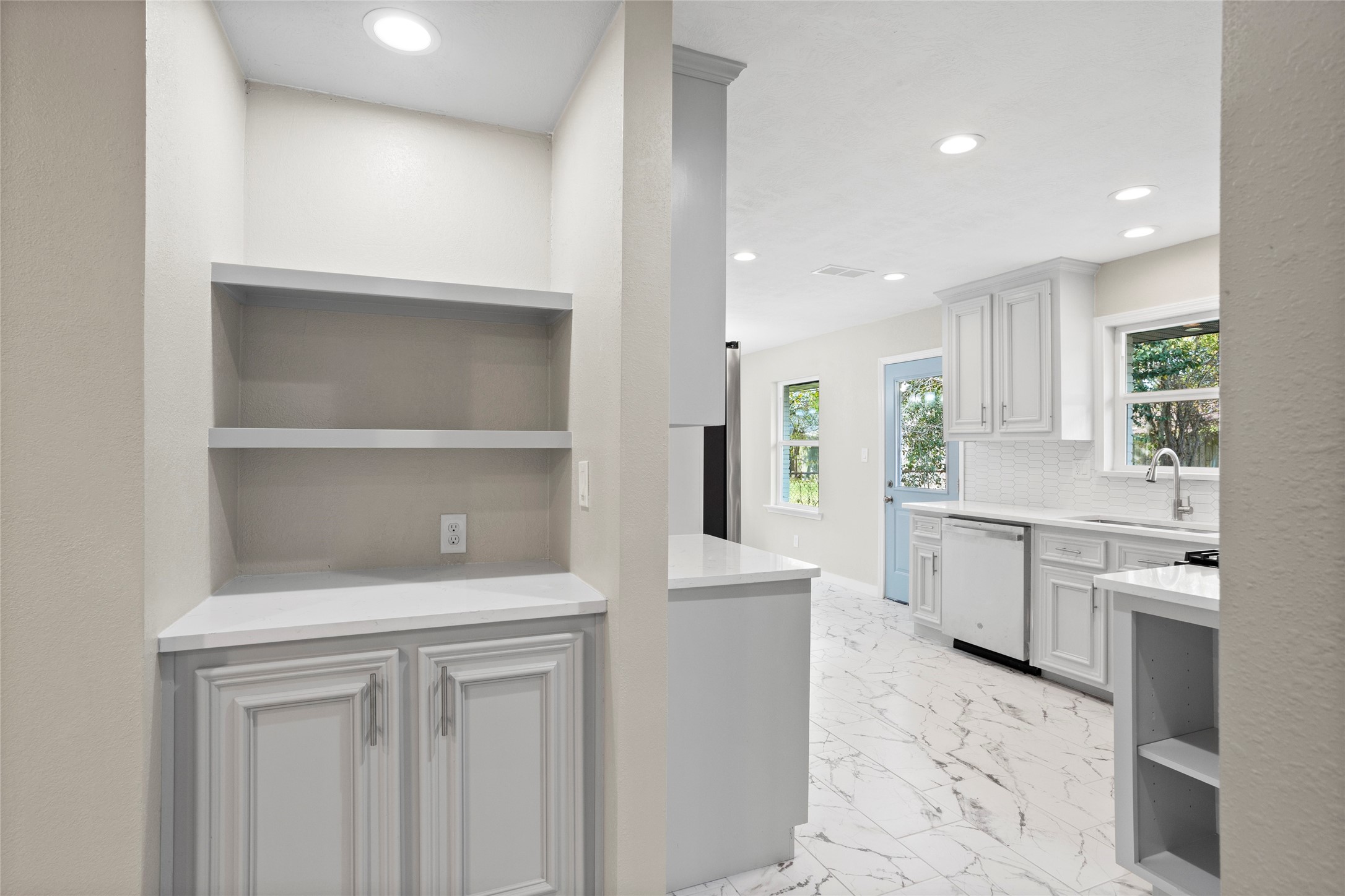 10127 Tolman Street Houston, TX 77034 - Photo 6 of 27 This coffee bar area is tucked into a dedicated alcove, offering a clean and organized extension of the kitchen's modern design.