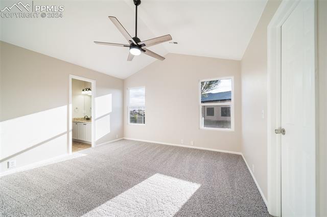 9356 Bethpage Road Peyton, CO 80831 - Photo 20 of 40 Carpeted empty room featuring vaulted ceiling and ceiling fan