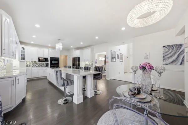 a large kitchen with kitchen island a stove a sink a refrigerator and a refrigerator