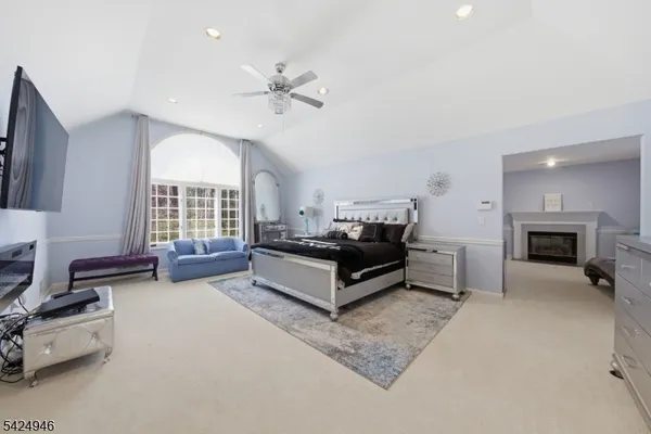 a living room with furniture ceiling fan and a flat screen tv