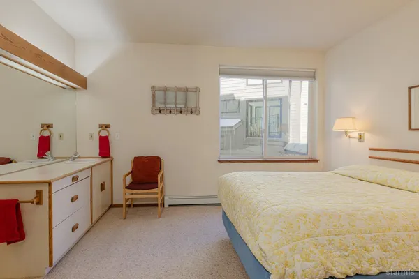 a bedroom with a bed and a chair