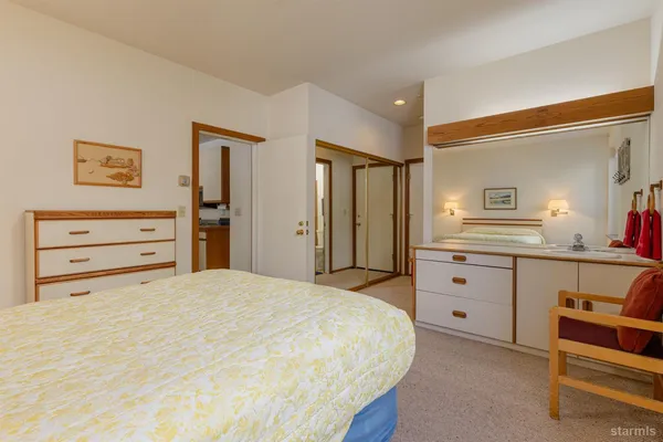 a bedroom with a bed and a dresser