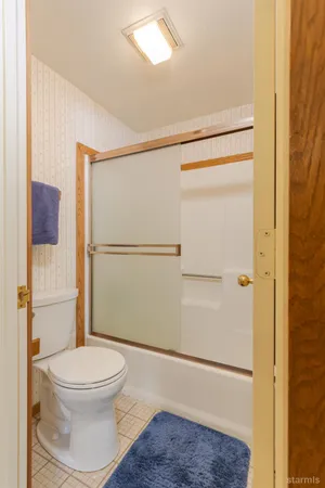 a bathroom with a toilet and a shower