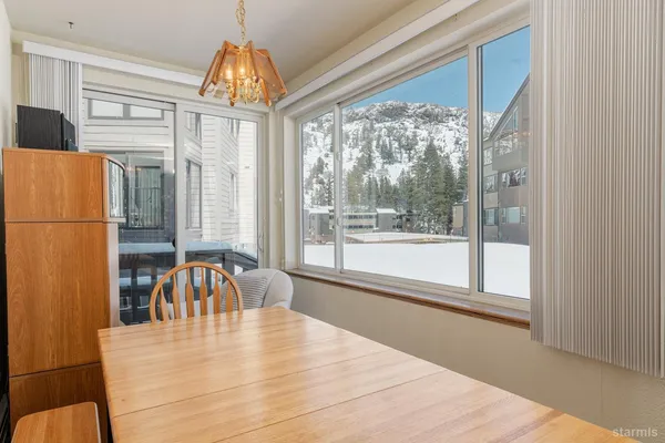 a view of a dining room with a table and chairs