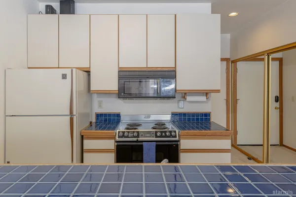 a kitchen with stainless steel appliances a refrigerator sink and cabinets