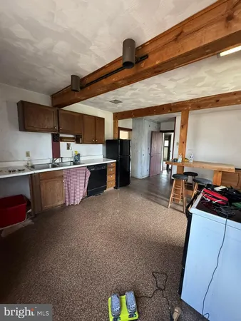 a kitchen with refrigerator and cabinets