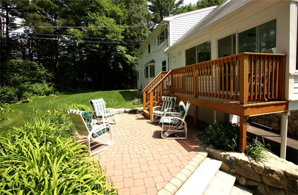 273 Conant Road Weston, MA 02493 - Photo 1 of 12 a view of a patio with table and chairs potted plants and large tree