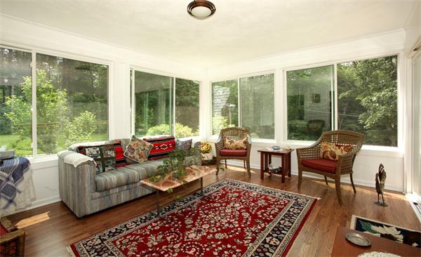 273 Conant Road Weston, MA 02493 - Photo 4 of 12 a living room with furniture floor to ceiling window and a table